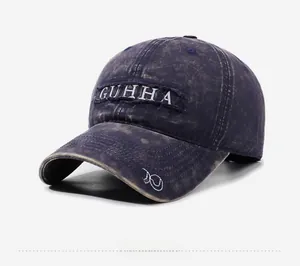 Detail view of washed denim baseball cap with GUHHA embroidery and infinity symbol