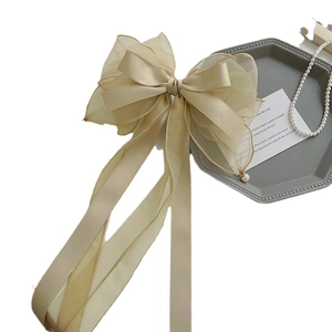 Elegant champagne satin and organza bow hair clip with pearl tassels and ribbons