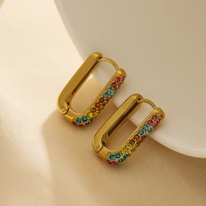Macro detail of gold-plated rectangular hoop earrings with colorful zircon inlay