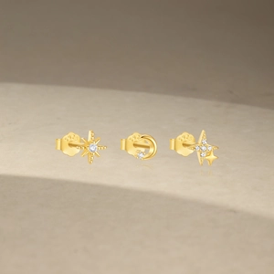 Macro shot of S925 sterling silver gold stud earrings with cubic zirconia star and moon