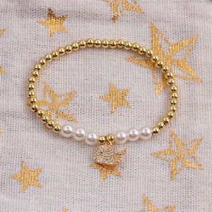 Elegant gold bead and pearl stretch bracelet with a crystal-encrusted dolphin charm