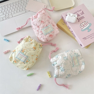 Quilted cotton drawstring camera pouches in floral and bear patterns for travel storage