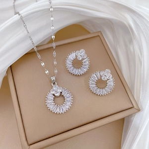 Silver steel clover jewelry set with necklace and earrings featuring cubic zirconia rings