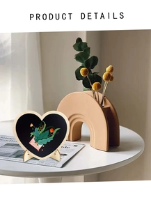 Detail of heart-shaped PVC chalkboard with wooden stand and floral envelope illustration