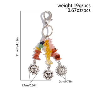 Detail of star and moon keychain showing dimensions 11.5cm and 19g weight with sun pendants