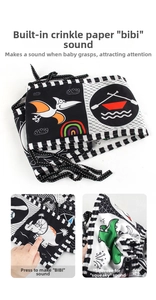 Detail of baby sensory cloth book with built-in squeaker and high contrast dinosaur patterns