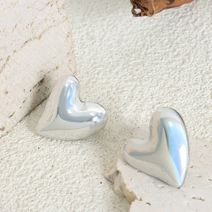 Elegant polished silver heart stud earrings made of titanium steel on natural stone base
