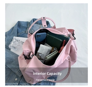 Pink waterproof nylon gym bag showing large interior capacity with organized essentials