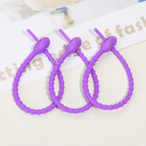 Detailed view of three purple silicone cable ties with non-slip perforated locking head