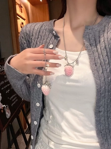 Detail of pink strawberry pendant with silver bead chain and faux pearl accent