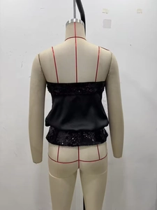 Detail of black sequined patchwork tube top showing texture and back zipper on mannequin