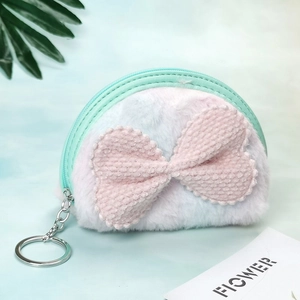 Close-up of semi-circular plush coin purse with pink bow and gradient mint faux fur