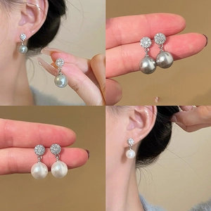 Detail view of pearl earrings with micro-set zircons in white and grey styles
