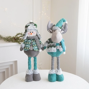 Detail of Christmas snowman and reindeer dolls in mint green and grey knitted fabric