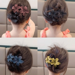 Detailed back view of matte double flower hair clips in four elegant colors on hair