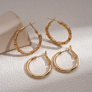 Minimalist gold geometric hoop earrings with twisted and smooth textured designs