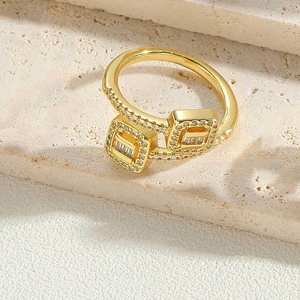 Detailed view of gold plated adjustable ring with square zircon settings on stone
