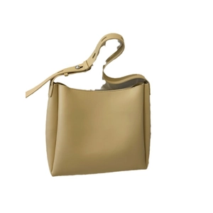 Minimalist beige leather tote bag with a large capacity and adjustable shoulder strap