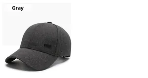 Macro shot of dark grey baseball cap with woven texture and side metal rectangle plate