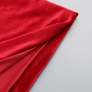Detail of red velvet fabric texture with smooth sheen and soft drape for elegant gowns
