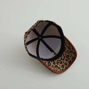 Detail view of leopard print baseball cap featuring inner lining and brown suede brim
