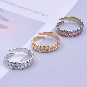 Three braided stainless steel open rings in silver, gold, and rainbow metallic finishes