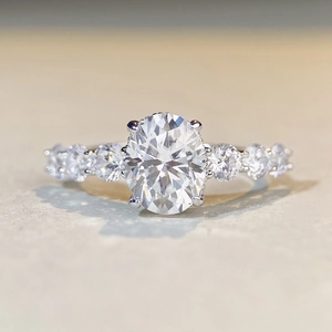 S925 sterling silver ring with 2 carat oval moissanite and side stones in macro view