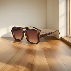 Classic tortoiseshell double bridge sunglasses with brown gradient lenses on wood