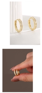 Macro detail of gold plated S925 silver hoop earrings with rectangular zircon inlay