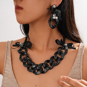 Statement acrylic chunky chain necklace and earrings set with black ribbon bows