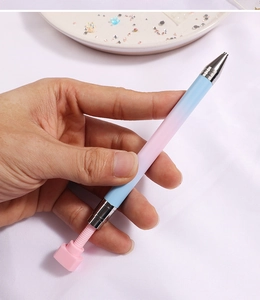 Close-up of pink and blue gradient nail dotting pen with dual metal ends for rhinestones