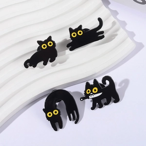 Set of four cute black cat enamel pins made of alloy on a white wavy background
