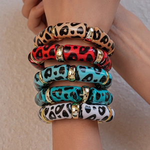 Close-up of heart leopard print resin bracelets with gold spacers on a model wrist