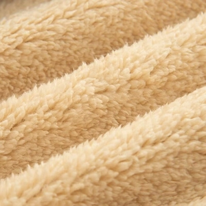 Macro shot of high-density cream sherpa fleece fabric showing soft fiber texture