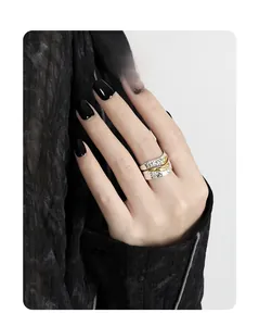 Detail of s925 silver wide ring with hammered texture and golden feather relief