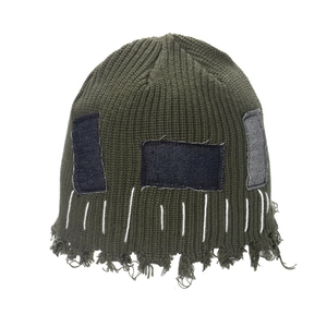 Green knit beanie with denim patches and frayed distressed details for a vintage look