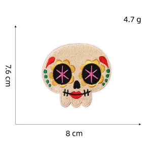 Detailed view of candy skull embroidery patch showing 7.6x8cm dimensions and 4.7g weight