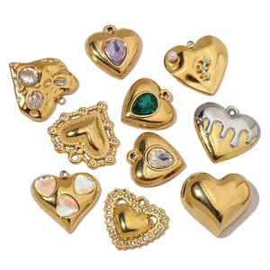 Luxury heart-shaped stainless steel charms with crystals and pearls on white background