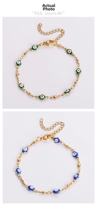Detail of gold-plated Hamsa and Evil Eye bracelets with green and blue enamel pendants