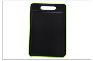 Macro detail of a multifunctional black aluminum thawing cutting board with green border