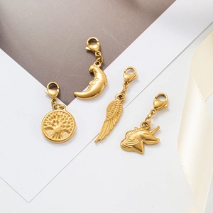 Golden stainless steel charm set featuring tree of life, moon, wing and unicorn with lobster clasps