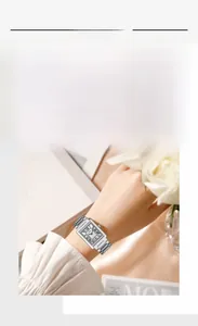 Detail of silver rectangular vintage watch with Roman numerals and stainless steel band