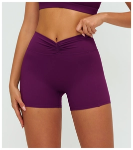 Close-up of high-waist purple yoga shorts featuring V-shape scrunch detail for tummy control