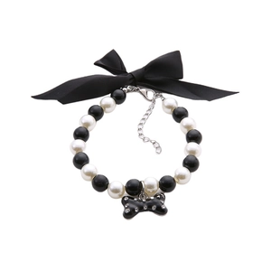 Elegant pet necklace with black bow, pearls and a rhinestone bone pendant accessory