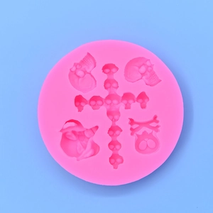Pink silicone Halloween mold with skull and crossbones designs for DIY cake baking