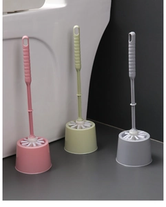 Three bathroom toilet brush sets in pink, green, and grey with matching base holders
