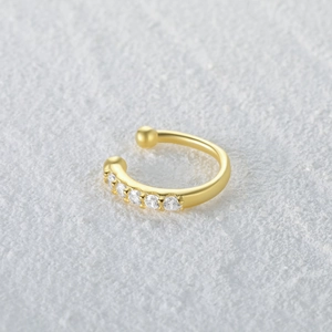Macro shot of gold-plated S925 silver nose cuff with sparkling cubic zirconia pavé