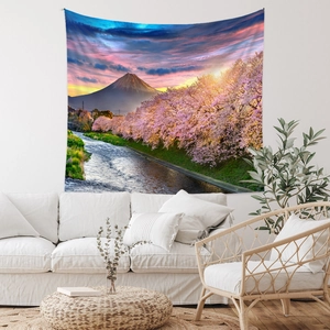Detail of Mount Fuji tapestry featuring cherry blossoms over a white sofa in a cozy room