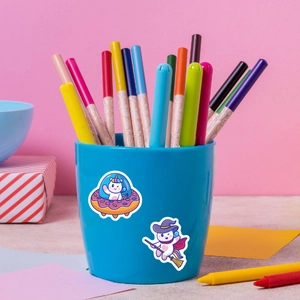 Close-up of cute cartoon unicorn stickers applied on a blue pencil holder desk organizer