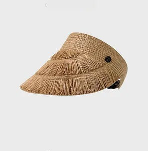 Detailed side view of straw sun visor featuring multi-layer fringe trim and D logo buckle
